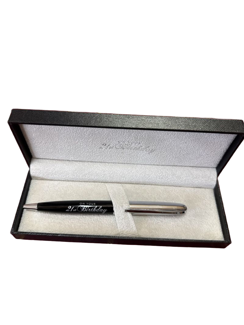 Pen with engraved text in an open black box on a white background