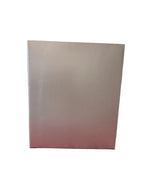 White box on a red surface with a blurred store interior in the background