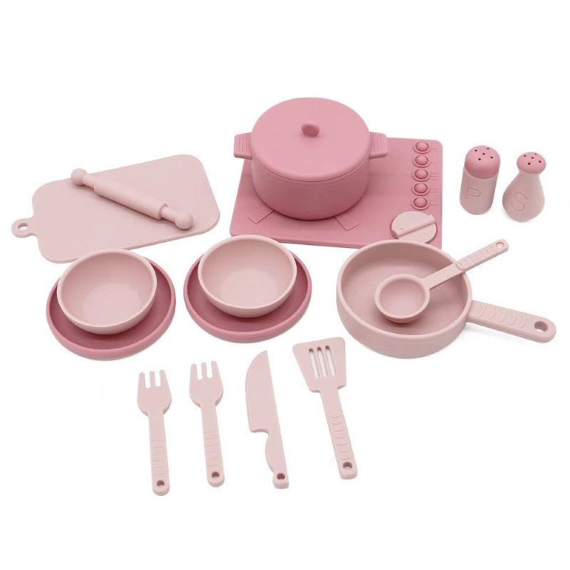 Set of pink toy kitchen utensils and cookware on a white background